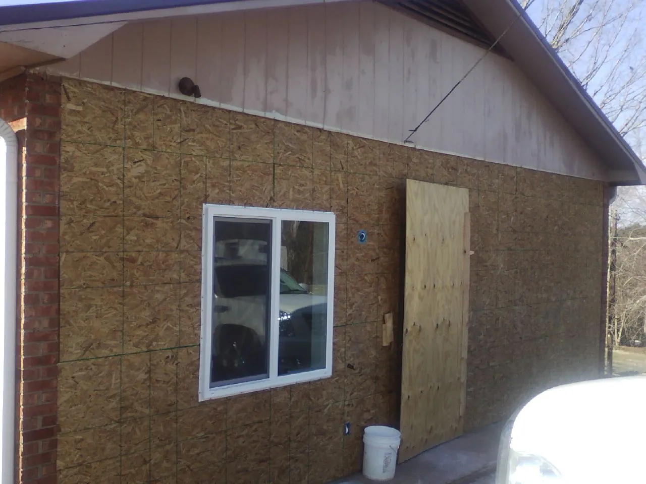 OSB sheathing on a garage addition wall before siding in Royal City
